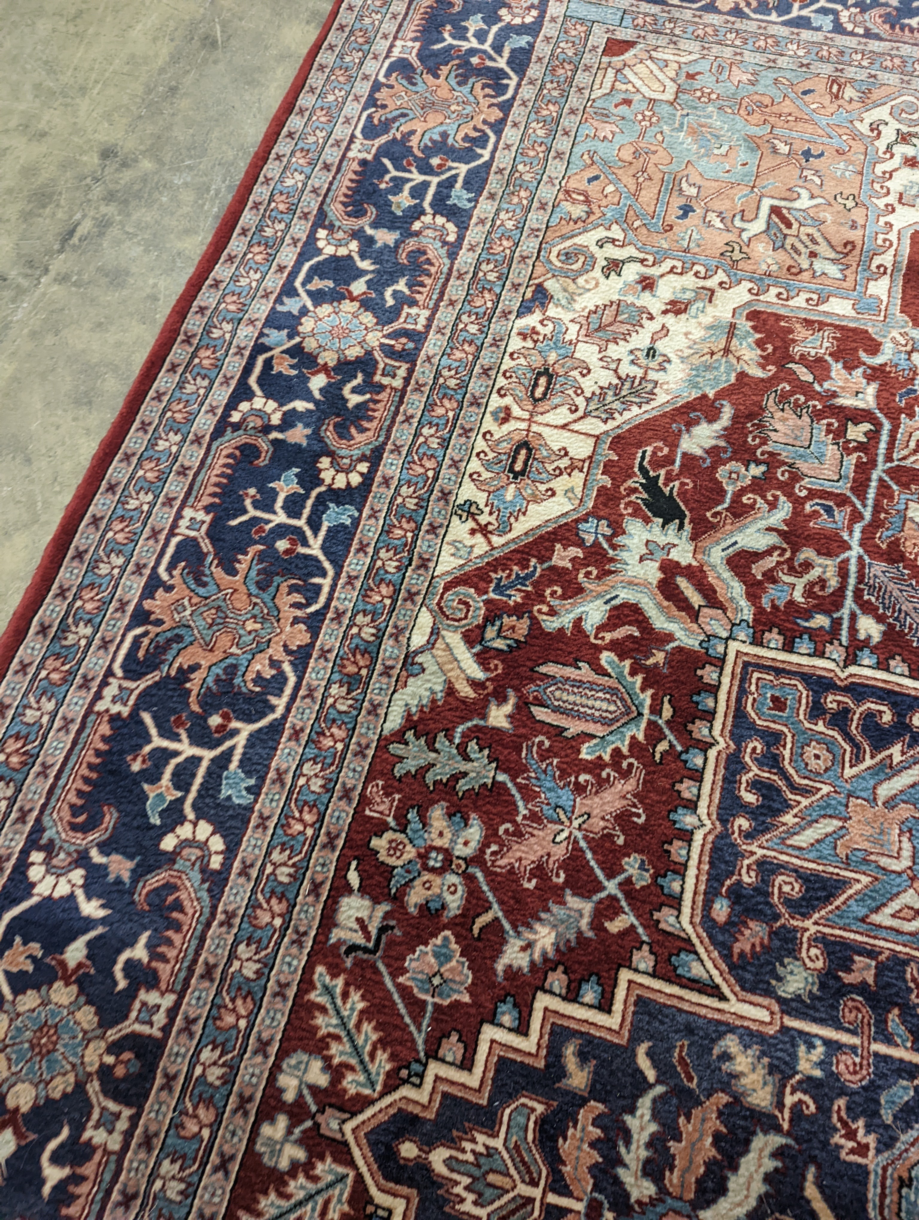 A large Caucasian style red ground carpet, 460 x 330cm